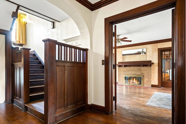 546 Elmwood Ct, El Paso, IL 61738 - stairs with ceiling fan, wood-type flooring, crown molding, a fireplace, and baseboards