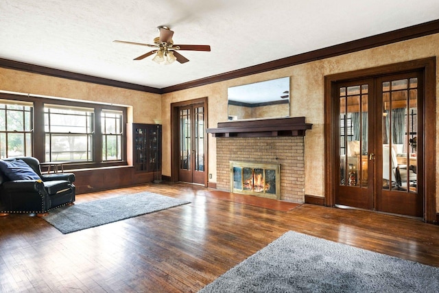 546 Elmwood Ct, El Paso, IL 61738 - living room with wood finished floors, a ceiling fan, crown molding, a fireplace, and french doors