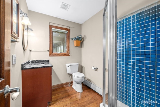 45W251 Ic Trl, Maple Park, IL 60151 - bathroom with a stall shower, wood finished floors, toilet, a baseboard heating unit, and vanity