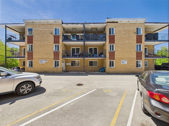 10033 Irving Park Rd Unit 1A, Schiller Park, IL 60176 - view of apartment building / complex featuring uncovered parking