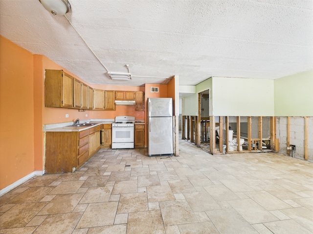 10033 Irving Park Rd Unit 1A, Schiller Park, IL 60176 - kitchen with freestanding refrigerator, white gas stove, under cabinet range hood, light countertops, and light stone finish floors
