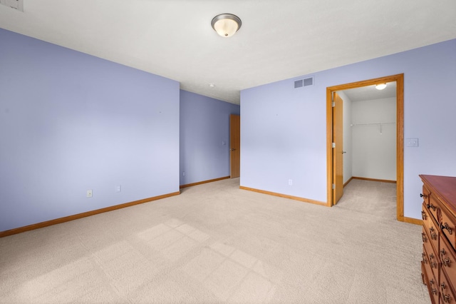 unfurnished room featuring carpet and baseboards