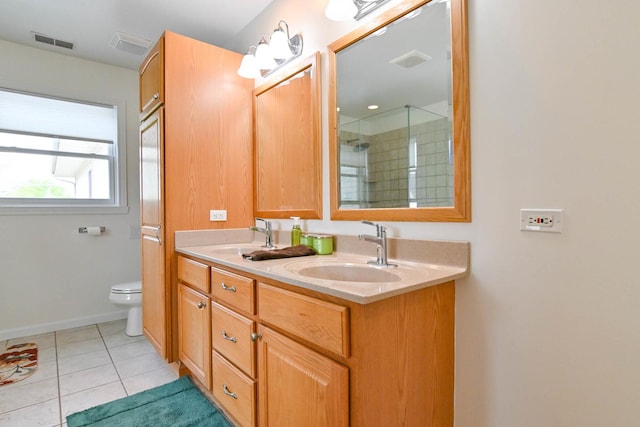 14445 W Walden Ln, Wadsworth, IL 60083 - full bathroom featuring toilet, a tile shower, double vanity, tile patterned flooring, and baseboards