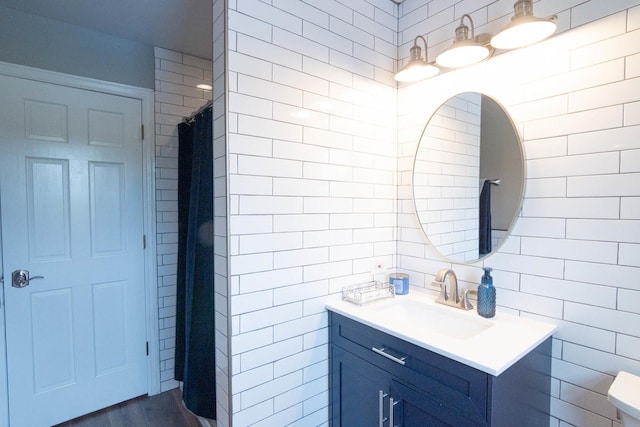 14445 W Walden Ln, Wadsworth, IL 60083 - bathroom featuring tile walls, vanity, wood finished floors, a shower with curtain, and toilet