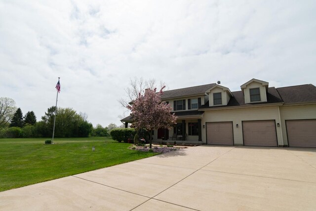 14445 W Walden Ln, Wadsworth, IL 60083 - view of front of home with a front yard, driveway, a garage, and covered porch