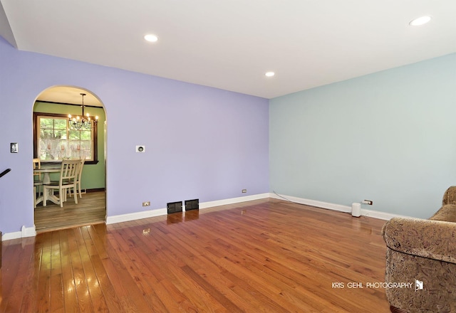 2810 Brentwood Ln, Mchenry, IL 60050 - unfurnished room with a chandelier, arched walkways, hardwood / wood-style flooring, baseboards, and recessed lighting
