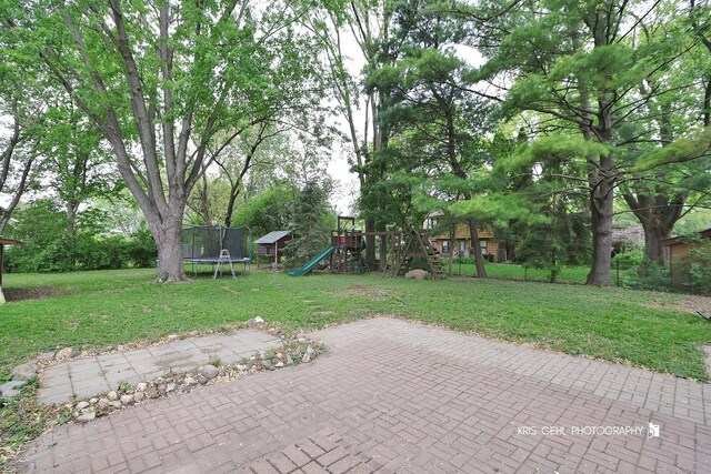 2810 Brentwood Ln, Mchenry, IL 60050 - view of green lawn featuring a playground, a trampoline, and a patio