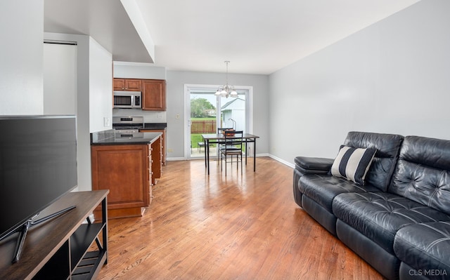 658 Cutter Ln, Elk Grove Village, IL 60007 - living area with a chandelier, light wood-style floors, and baseboards