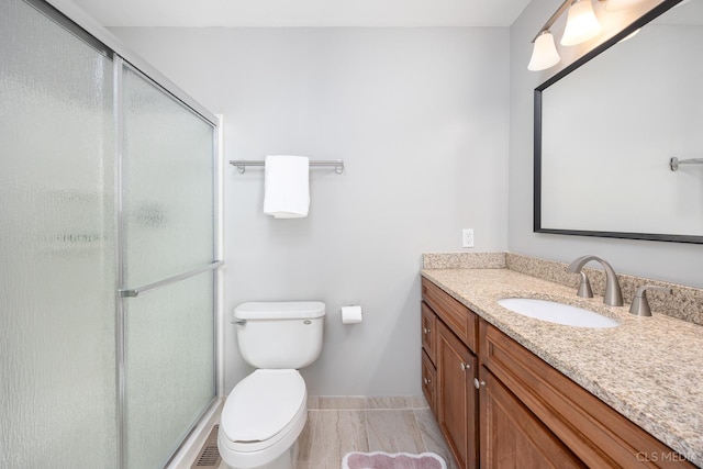 658 Cutter Ln, Elk Grove Village, IL 60007 - bathroom with vanity, toilet, a shower stall, and baseboards