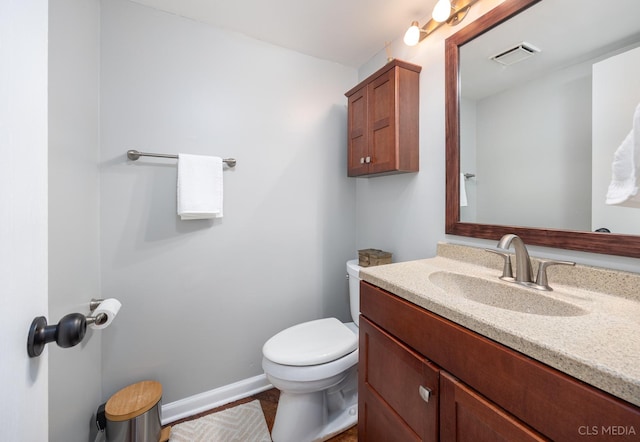 658 Cutter Ln, Elk Grove Village, IL 60007 - bathroom with toilet, vanity, and baseboards