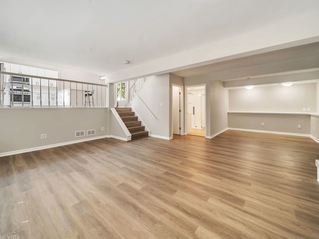 1150 Jerald Dr, Joliet, IL 60431 - spare room with wood finished floors, stairs, and baseboards