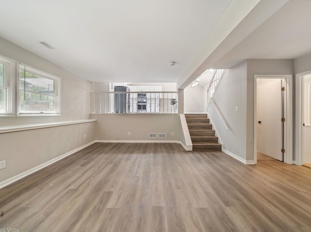 1150 Jerald Dr, Joliet, IL 60431 - unfurnished living room with wood finished floors, stairs, and baseboards