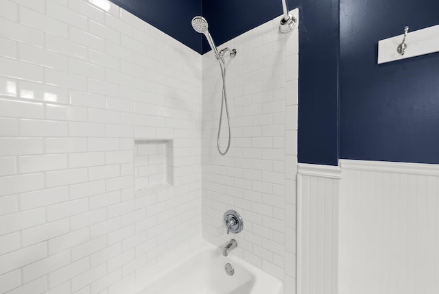 bathroom with wainscoting and shower / bath combination