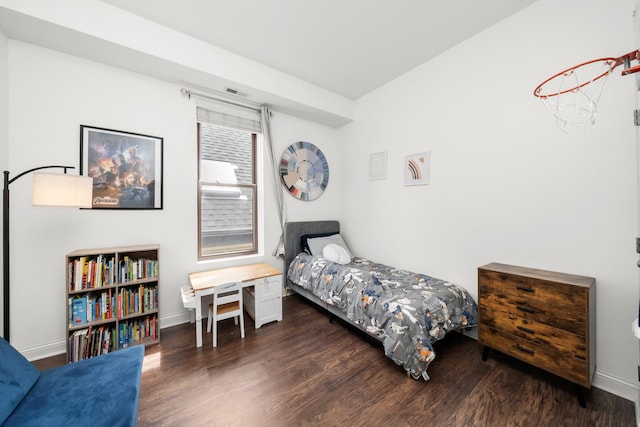 bedroom featuring wood finished floors and baseboards