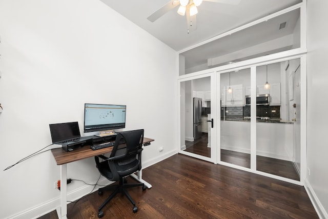 office space with a ceiling fan, wood finished floors, and baseboards