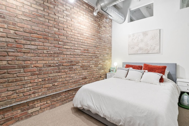 carpeted bedroom featuring brick wall