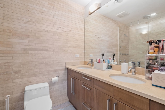full bath featuring a shower stall, toilet, tile walls, and double vanity