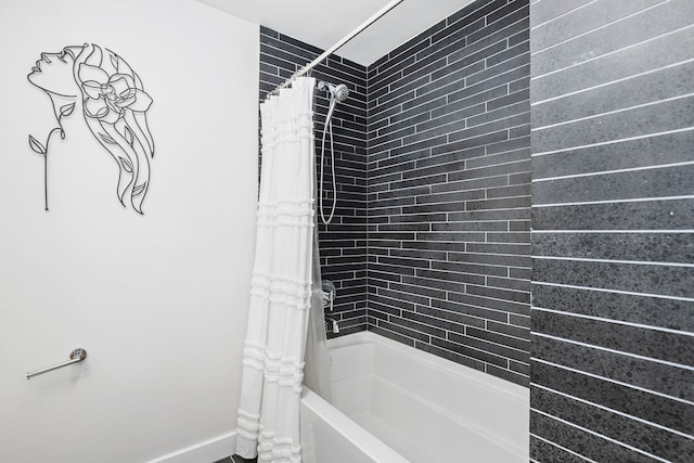 full bathroom with baseboards and shower / tub combo