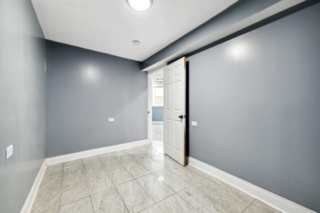 6748 S Wabash Ave, Chicago, IL 60637 - empty room with baseboards and light marble finish flooring