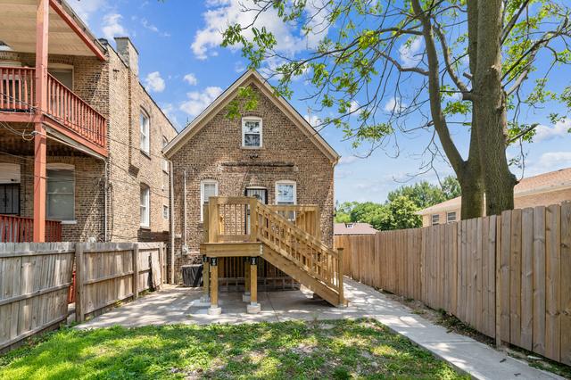 6748 S Wabash Ave, Chicago, IL 60637 - rear view of property featuring a fenced backyard, a patio area, and brick siding