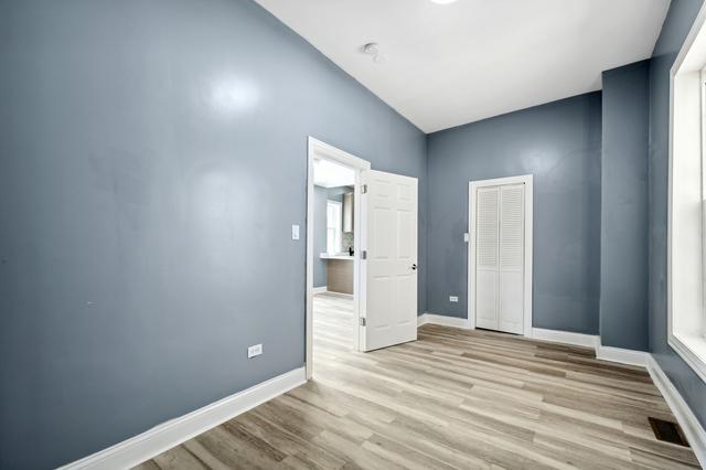6748 S Wabash Ave, Chicago, IL 60637 - empty room featuring wood finished floors and baseboards