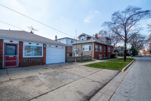view of front facade featuring brick siding, driveway, and a garage