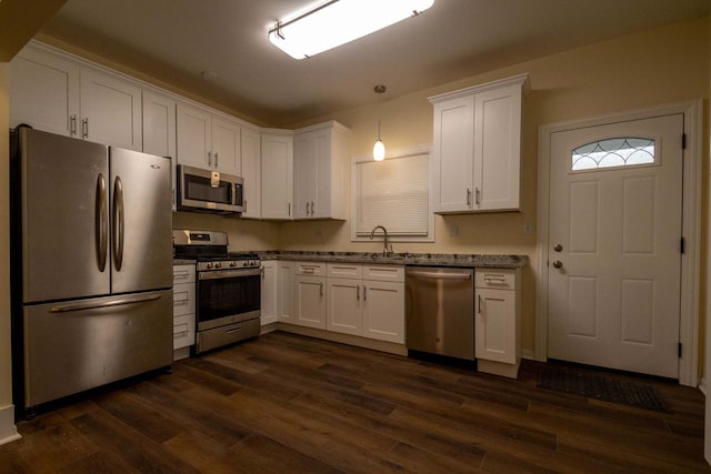 kitchen featuring stainless steel appliances, dark wood-type flooring, and white cabinetry