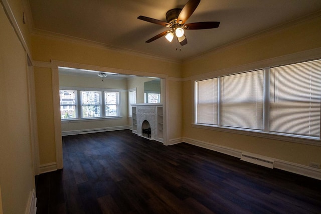 unfurnished living room featuring ceiling fan, dark wood-style flooring, crown molding, baseboards, and a fireplace