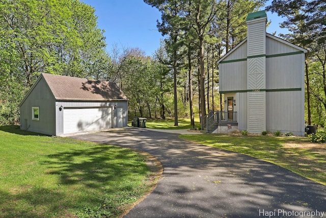 22665 W Depot St, Antioch, IL 60002 - view of property exterior with an outbuilding, a garage, a yard, a chimney, and roof with shingles