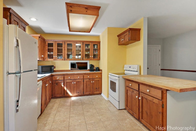 22665 W Depot St, Antioch, IL 60002 - kitchen with white appliances, brown cabinetry, glass insert cabinets, light tile patterned floors, and recessed lighting