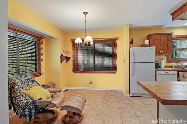 22665 W Depot St, Antioch, IL 60002 - dining space featuring a chandelier, light tile patterned flooring, and baseboards