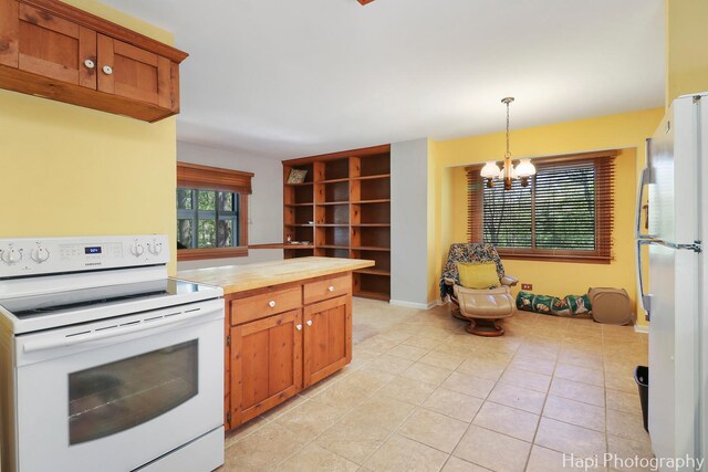 22665 W Depot St, Antioch, IL 60002 - kitchen featuring white appliances, pendant lighting, a chandelier, light tile patterned floors, and brown cabinets