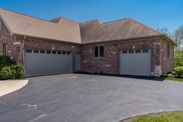 5344 River Run Parkway, Belvidere, IL 61008 - view of front of home with a garage, brick siding, driveway, and roof with shingles