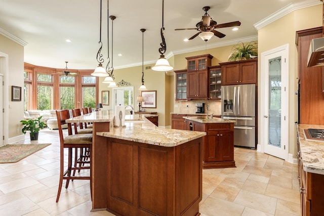 5344 River Run Parkway, Belvidere, IL 61008 - kitchen featuring appliances with stainless steel finishes, a kitchen island with sink, a ceiling fan, a breakfast bar, and tasteful backsplash