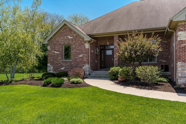 5344 River Run Parkway, Belvidere, IL 61008 - view of front of house featuring a front lawn, roof with shingles, and brick siding