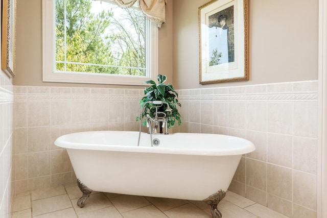 5344 River Run Parkway, Belvidere, IL 61008 - full bath with tile walls, a freestanding bath, tile patterned flooring, and wainscoting