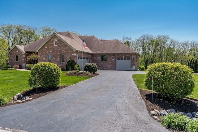 5344 River Run Parkway, Belvidere, IL 61008 - view of front of home with an attached garage, brick siding, a front yard, and asphalt driveway