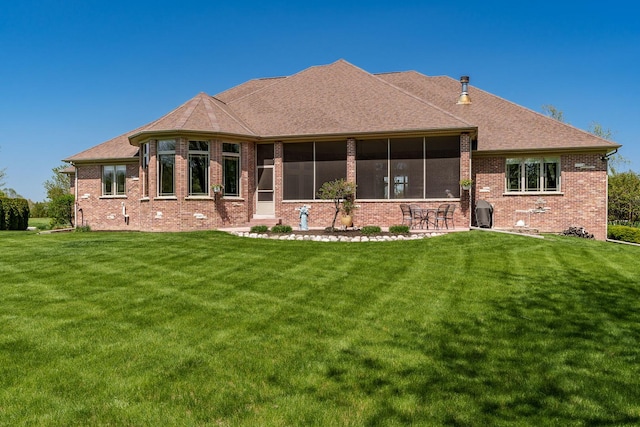 5344 River Run Parkway, Belvidere, IL 61008 - back of house with a sunroom, a lawn, and brick siding