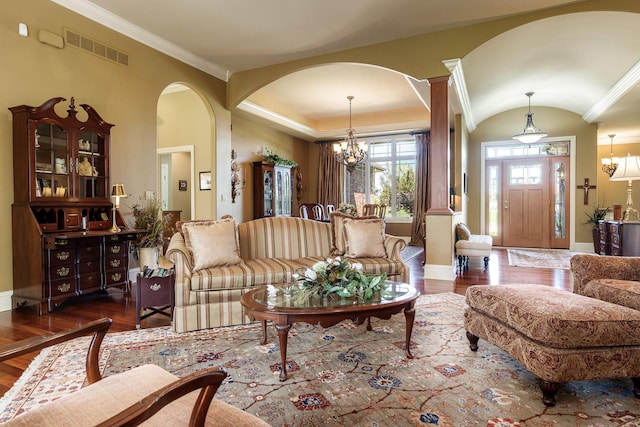 5344 River Run Parkway, Belvidere, IL 61008 - living room featuring wood finished floors, a chandelier, crown molding, arched walkways, and baseboards
