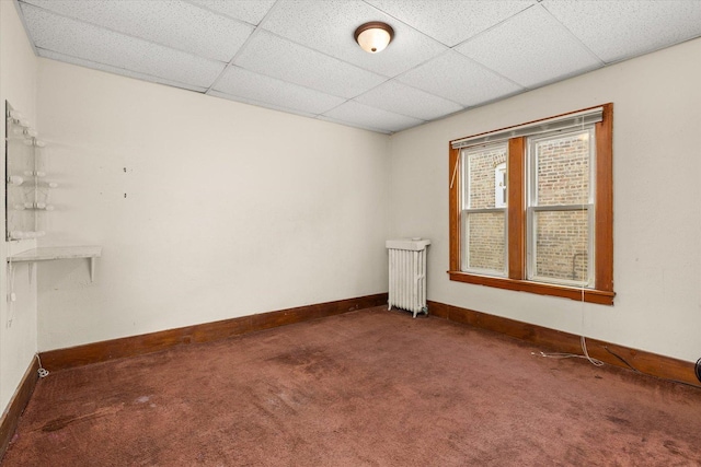 711 Mason Ave, Joliet, IL 60435 - carpeted spare room with radiator heating unit and a drop ceiling