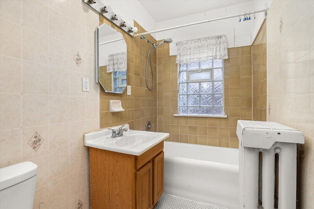 711 Mason Ave, Joliet, IL 60435 - bathroom with tile walls, vanity, tile patterned flooring, bathtub / shower combination, and radiator