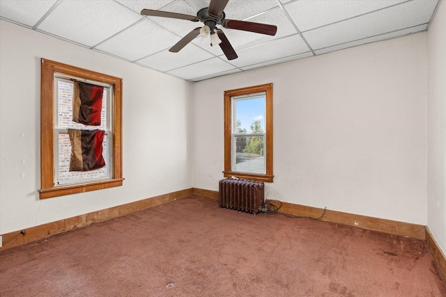 711 Mason Ave, Joliet, IL 60435 - carpeted spare room with radiator, a drop ceiling, and a ceiling fan