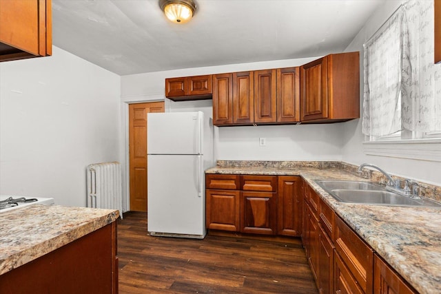 711 Mason Ave, Joliet, IL 60435 - kitchen featuring freestanding refrigerator, radiator heating unit, dark wood-type flooring, and brown cabinetry