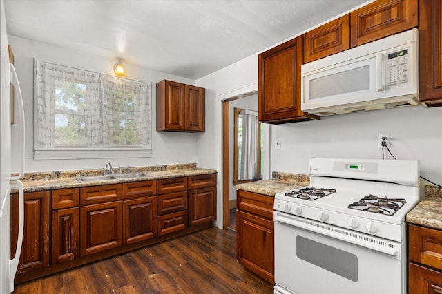 711 Mason Ave, Joliet, IL 60435 - kitchen featuring white appliances, dark wood-style floors, healthy amount of natural light, and brown cabinets