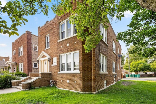 711 Mason Ave, Joliet, IL 60435 - view of front of house with brick siding and a front lawn