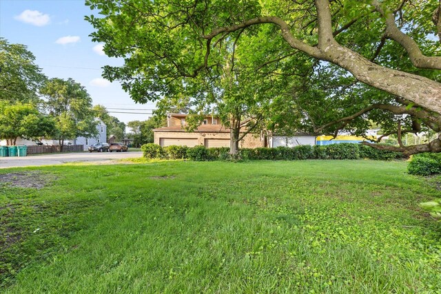 711 Mason Ave, Joliet, IL 60435 - view of grassy yard with an attached garage
