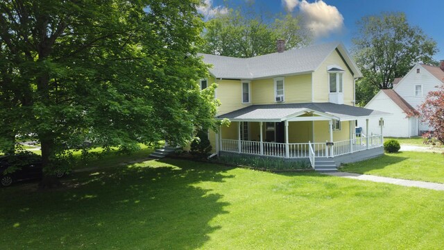 407 E Mulberry St, Watseka, IL 60970 - view of front of house featuring covered porch, a shingled roof, a front lawn, and a chimney