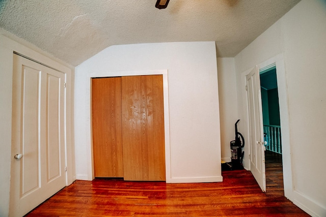 407 E Mulberry St, Watseka, IL 60970 - unfurnished bedroom featuring a textured ceiling, wood finished floors, vaulted ceiling, ceiling fan, and baseboards