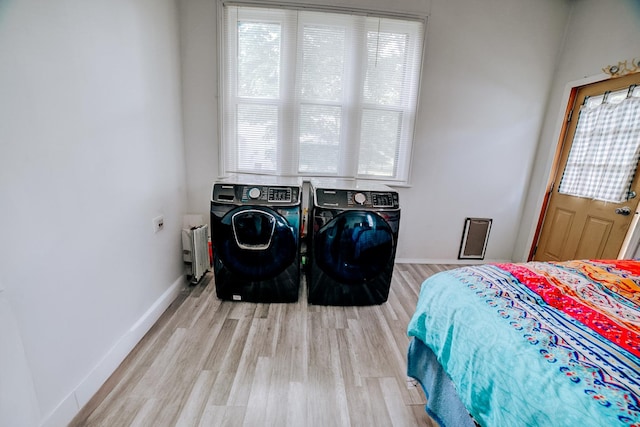 407 E Mulberry St, Watseka, IL 60970 - bedroom with washer and clothes dryer, wood finished floors, radiator, and baseboards