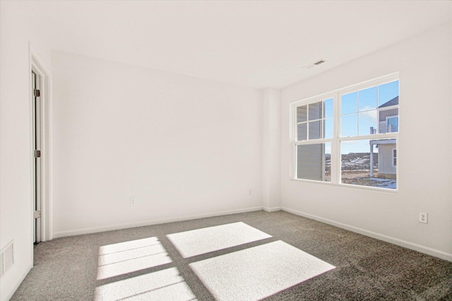 carpeted empty room with baseboards